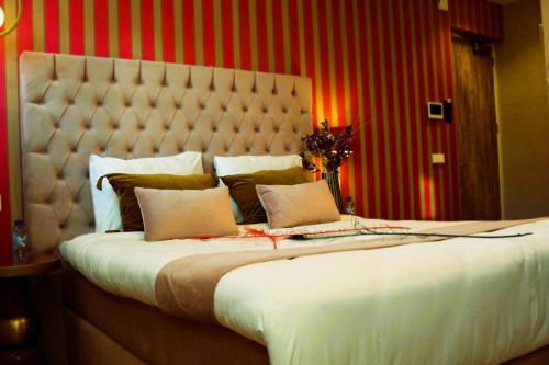 a bedroom with a large bed with a large headboard at The LIF Boutique in Amsterdam