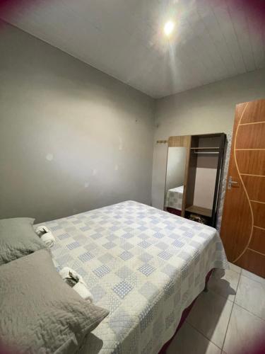 a small bedroom with a bed and a mirror at Sua casa completa em Viçosa do Ceará in Viçosa do Ceará