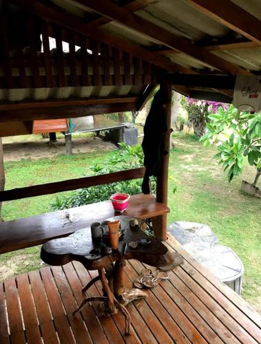 a wooden deck with a table on top of it at Angthong Beach Resort in Koh Phaluai