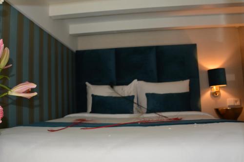 a bedroom with a large bed with a blue headboard at The LIF Boutique in Amsterdam
