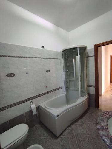 a bathroom with a toilet and a bath tub at Casa nei pini in Varazze