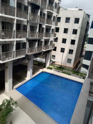 an aerial view of an apartment building with a swimming pool at The Manor at S Residences in Manila
