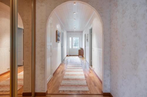 an arched hallway with an archway in a home at Arctic Countryside House in Rovaniemi