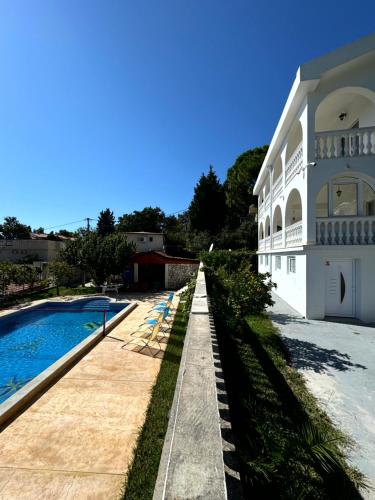 a house with a swimming pool next to a building at Sunset Pool Retreat in Zagrađe