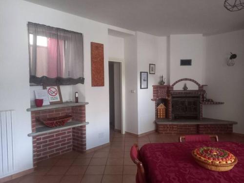 a living room with a table and a fireplace at Da Elena e Michele in Coazze