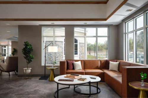 a living room with a couch and a table at Inn at Bellefield Residence Inn by Marriott in Hyde Park