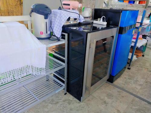 an open refrigerator with its door open in a kitchen at Baan Mai-on Poolvilla in Surat Thani