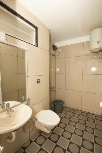 a bathroom with a toilet and a sink at Lazo Silver Lake , Ooty in Ooty
