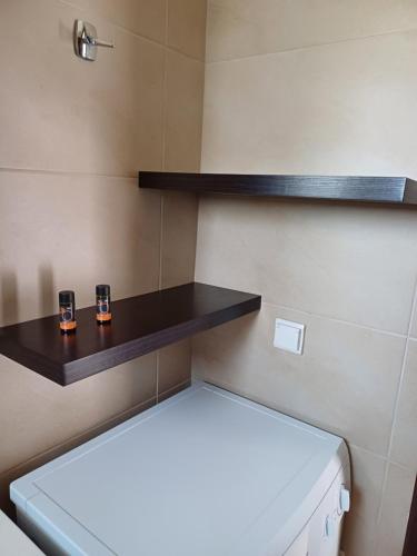 a bathroom with a toilet and shelves on the wall at Angelica-Sea & Mountain View in Georgioupolis