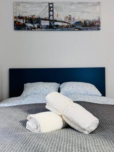 a bed with two white pillows and a bridge at Tallinn Downtown 1BR apartment with parking in Tallinn