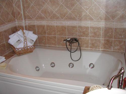 a bath tub in a bathroom with a basket at Madre Terra in La Puebla de la Sierra