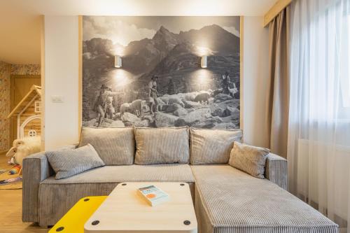 a living room with a couch and a painting on the wall at Panocek i Babka in Białka Tatrzanska