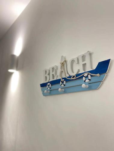 a blue and white sign on a white wall at Casa Vacanze Cimo Marine Style in Civitanova Marche
