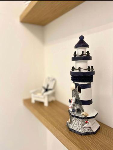 a model of a lighthouse sitting on a shelf at Casa Vacanze Cimo Marine Style in Civitanova Marche
