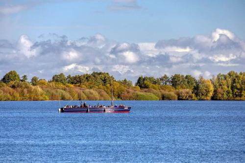 a group of people on a boat on a lake at Seeliebe, 300 Meter zum Wasser, mit Terrasse und Garten in Lembruch