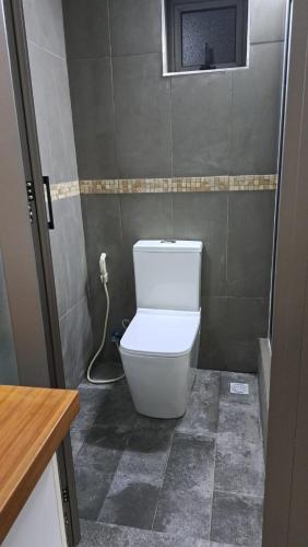 a bathroom with a white toilet in a room at Gris Gris Studio 2 in Souillac