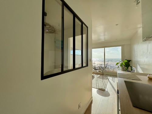 a kitchen with a large mirror on the wall at Azur à la Chaume in Les Sables-dʼOlonne