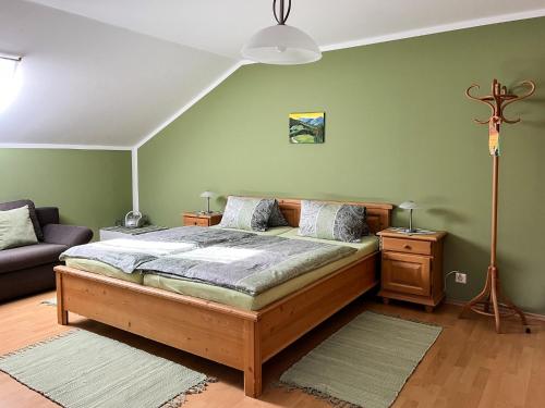 a bedroom with a bed and a couch at Obermerkenbergerhof in Hofstetten