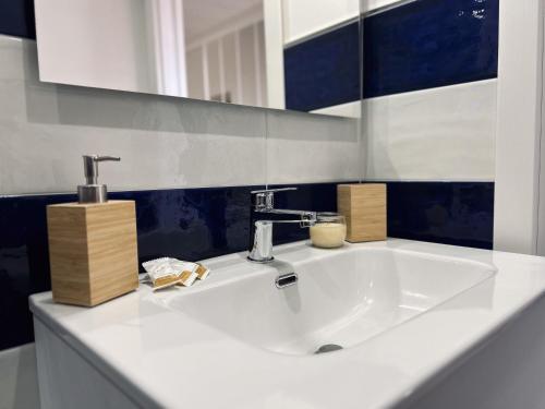 a bathroom with a white sink and a mirror at Al Borghetto in Vico Equense