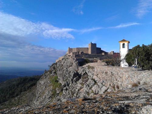 a castle on the top of a mountain at Casa O Arco Alojamento Local in Marvão
