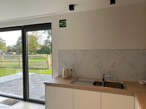 a kitchen with a sink and a counter top at Vakantiewoning Laurijn in Bilzen
