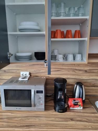 a microwave oven sitting on top of a kitchen counter at 1-2 Personen Zimmer in Kassel in Kassel