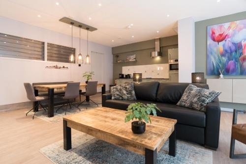 a living room with a couch and a table at Relaxed Apartments Haarlem in Haarlem