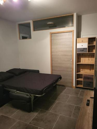 a room with a bed in a room with a door at Studio La Bâtie-Rolland in La Bâtie-Rolland