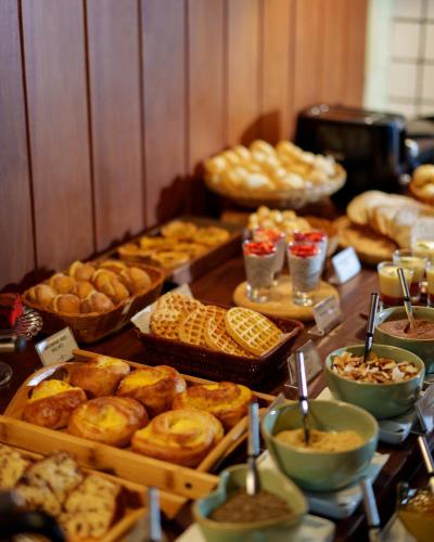 a table with many different types of bread and pastries at Parador Lumiar Boutique Hotel & Spa in Lumiar