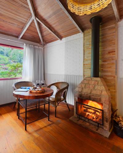 a room with a table and a fireplace at Parador Lumiar Boutique Hotel & Spa in Lumiar