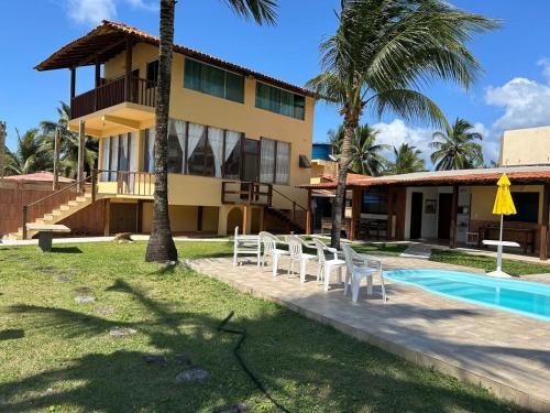 a resort with a swimming pool and a building at Casa Águas de Olivença - Pé na Areia in Olivença