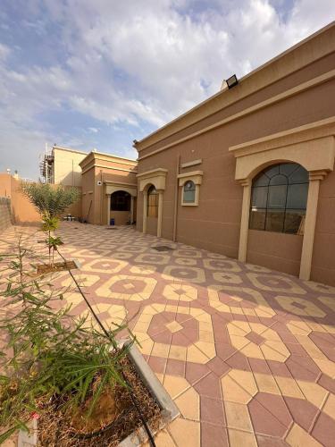 a building with a tiled patio in front of it at happy villa ras al khaimah chalet in Ras al Khaimah