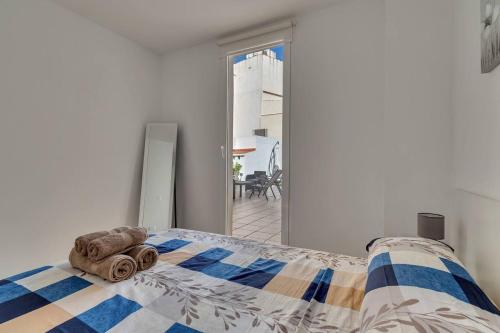a bedroom with a bed with a towel on it at Denia City Apartments Terrace & BBQ Experience in Denia