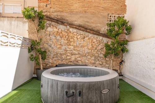a courtyard with a fire pit in the middle of a building at Denia City Apartments Terrace & BBQ Experience in Denia