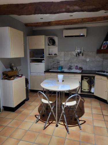 - une cuisine avec une table et deux chaises dans l'établissement chambre simple, à Antugnac