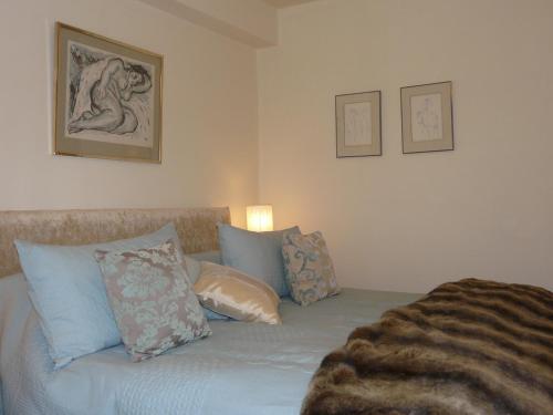 a bedroom with a bed with pillows on it at Annesdale House in Windermere