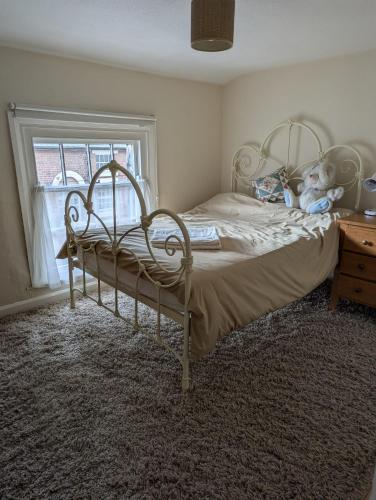 a bedroom with a bed with a teddy bear on it at Georgian Terrace Town House in Mid Wales in Newtown