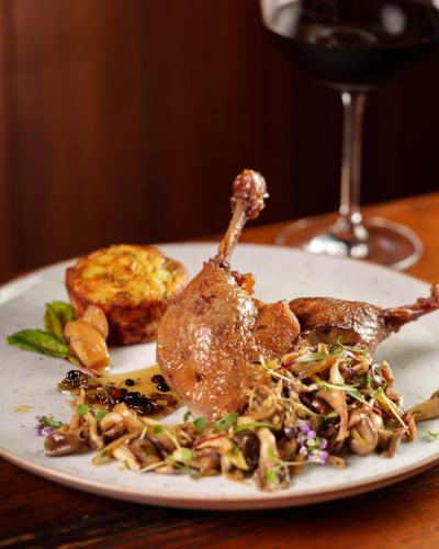 a plate of food on a table with a glass of wine at Parador Lumiar Boutique Hotel & Spa in Lumiar
