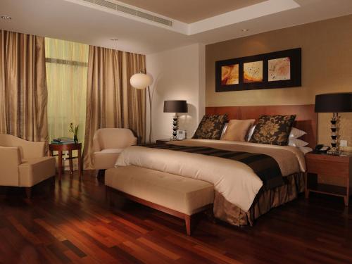 Кровать или кровати в номере Fraser Suites Seef Bahrain