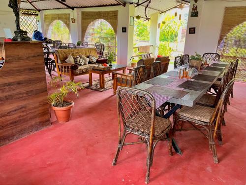 a dining room with a long table and chairs at Grand Narmada Jungle Homestay Resort-Bandhavgarh in Tāla