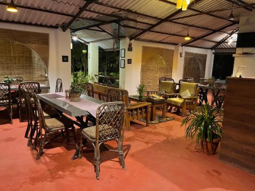 a patio with a table and chairs on a patio at Grand Narmada Jungle Homestay Resort-Bandhavgarh in Tāla