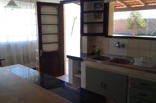 a kitchen with a sink and a counter top at Casa con piscina para 8 personas in Mercedes