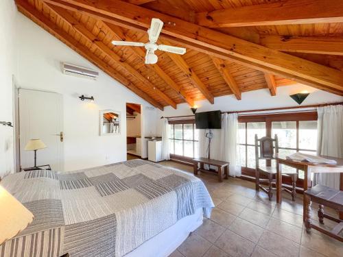 a bedroom with a large bed and a wooden ceiling at Pino Dorado in Punta del Este