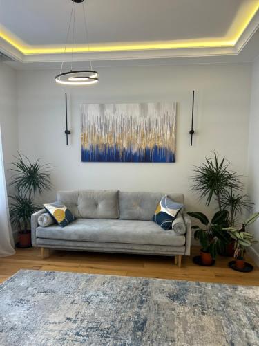 a living room with a couch and a painting on the wall at Stylish One Bed Flat in Paddington Pool and gym next door Free secure underground parking nearby in London