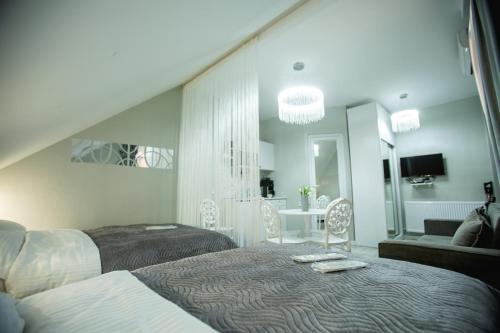 a bedroom with two beds and a living room at Golden Palace in Kutaisi