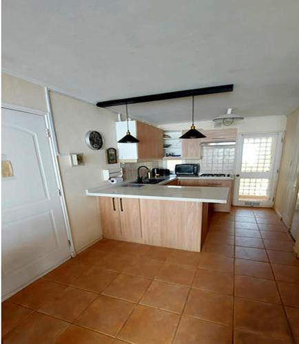 a kitchen with a sink and a counter top at Bahia Pelícanos Horcón depto. en primera línea in Puchuncaví