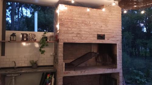a brick fireplace in a house with lights on it at Hermosa Casa en El Ensueño Santa Ana Colonia in Santa Ana