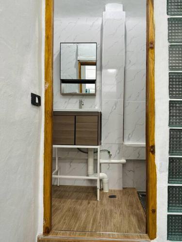 a bathroom with a sink and a mirror at Megun 10 Duplex in Bangkok