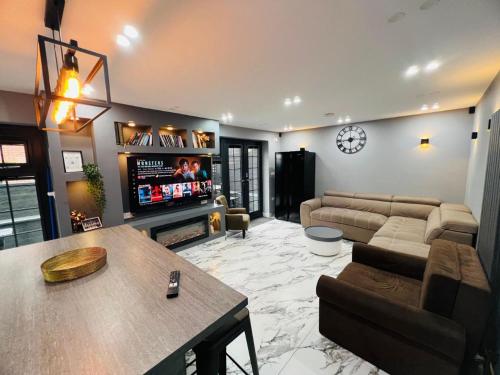a living room with a couch and a tv at Urban Escape 4BedRoom House- With Free private Parking - Birmingham City in Birmingham