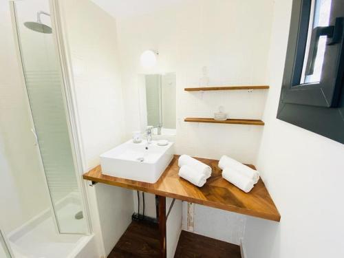 a bathroom with a sink and a mirror at La Villa Lou Castel in Sanary-sur-Mer